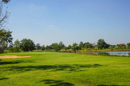 Beautiful golf course in a sunny day. Background evening golf course has sunlight shining down. Golf course in the countrysideの写真素材