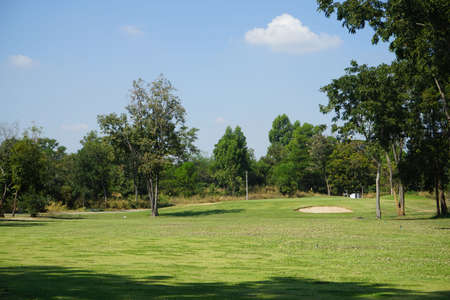 Beautiful golf course in a sunny day. Background evening golf course has sunlight shining down. Golf course in the countrysideの写真素材