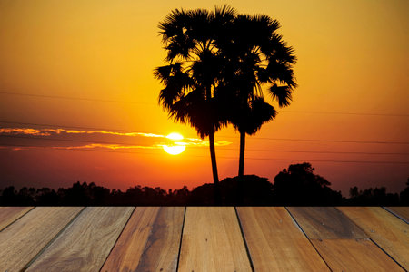 Empty wooden table on sunset nature background. Mock up for your product display or montageの写真素材