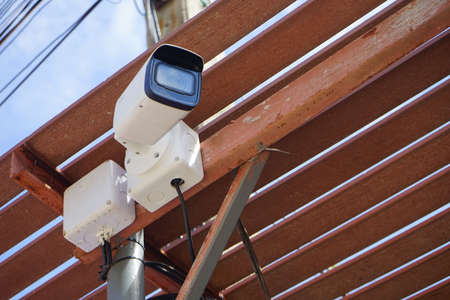 Dirty CCTV cameras are installed on the eaves for detecting property theft. CCTV security camera outdoors.の写真素材