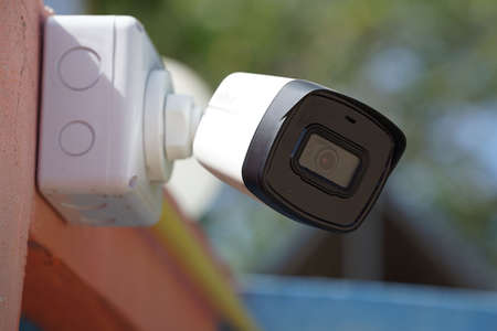 Dirty CCTV cameras are installed on the eaves for detecting property theft. CCTV security camera outdoors.の写真素材