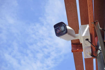 Dirty CCTV cameras are installed on the eaves for detecting property theft. CCTV security camera outdoors.の写真素材