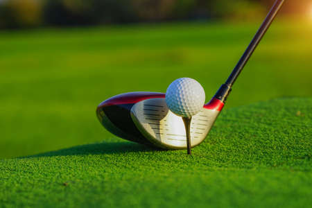 Golf club and ball in grass concetp.  Golf balls on the golf course with golf clubs ready for golf in the first short. In the morning, with the beautiful sunlight.Sports that people around the world play in the holidays.の写真素材