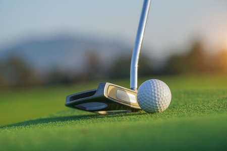 Golf club and ball in grass concetp.  Golf balls on the golf course with golf clubs ready for golf in the first short. In the morning, with the beautiful sunlight.Sports that people around the world play in the holidays.の写真素材
