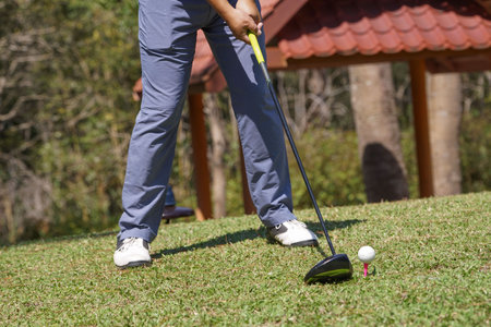 Golfers are putting golf in the evening golf course golf backglound. Golfer hitting golf ball. Sport holiday lifestyle Concept.の写真素材
