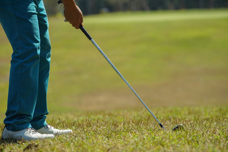 Golfer are playing game golf and hitting go on green grass mountain background. Asia male player game shot in summer. Sport holiday lifestyle concept.の写真素材