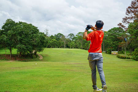Golfer playing golf in the evening golf course, on sun set evening time. Man playing golf on a golf...