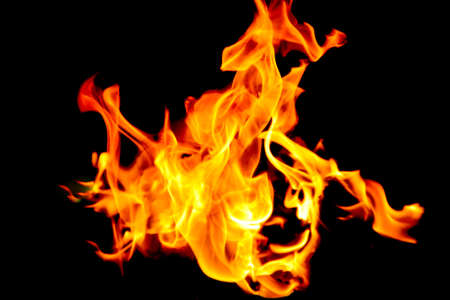 Fire flames on black background. The fire in the natural forest, flames and sparks on a dark background Fuel , lights on a black background.の写真素材