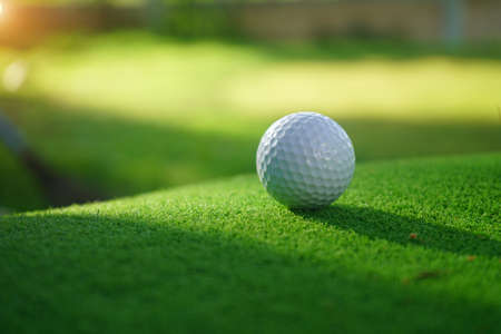 Golf balls on the golf course with golf clubs ready for golf in the first short. In the morning, with the beautiful sunlight.の写真素材