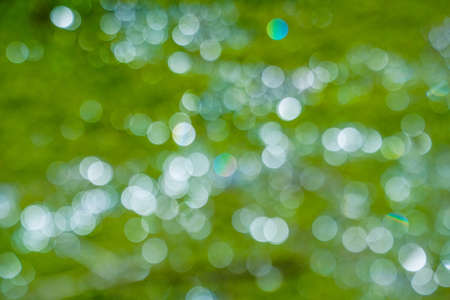 Abstract background of cold winter blue bokeh defocused blurred lights on background and glitter sparklesの写真素材