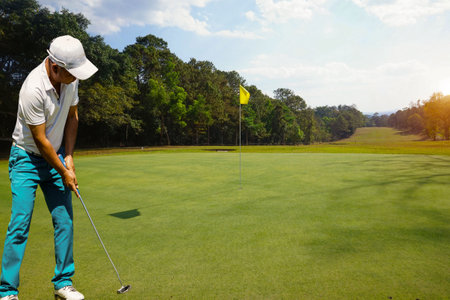 Background of evening golf course has sunlight shining down at golf course in Thailand. Nice scenery on a golf course at a late summer afternoon.の写真素材