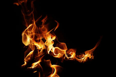 Burning flame or fire isolated on black background. stack of thermal energy close-up, red and yellow, heat energy igniting fuel during night/light on black backgroundの写真素材