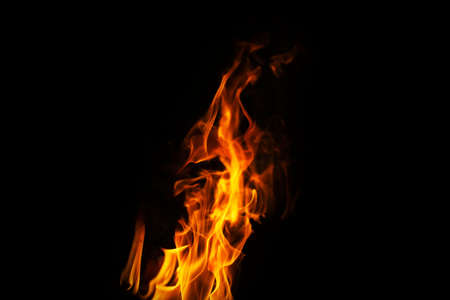 Burning flame or fire isolated on black background. stack of thermal energy close-up, red and yellow, heat energy igniting fuel during night/light on black backgroundの写真素材
