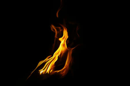 Burning flame or fire isolated on black background. stack of thermal energy close-up, red and yellow, heat energy igniting fuel during night/light on black backgroundの写真素材