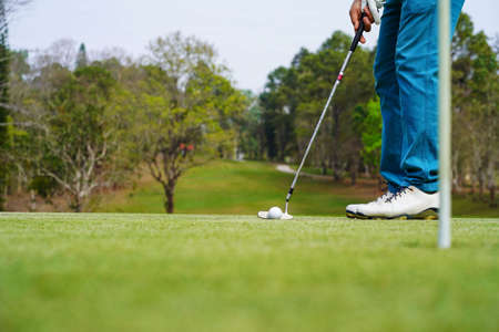 Golf ball on tee in beautiful golf course at sunset background.の写真素材