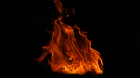 Stack of thermal energy close-up, red and yellow, heat energy igniting fuel during night/light on black background.の写真素材