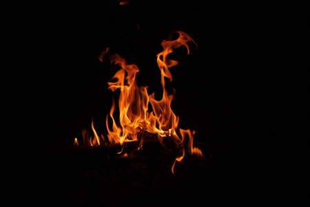 Fire flames on black background. abstract fire flame background. The fire in the fire burning naturally waved at night.の写真素材