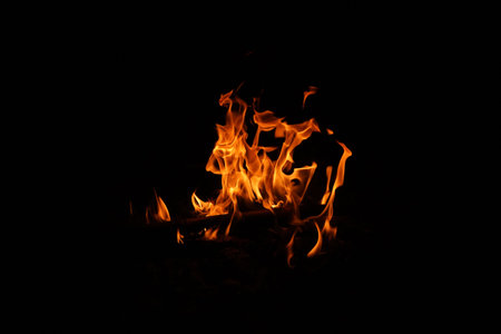 Fire flames on black background. abstract fire flame background. The fire in the fire burning naturally waved at night.の写真素材