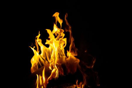 Burning flame or fire isolated on black background. stack of thermal energy close-up, red and yellow, heat energy igniting fuel during night,light on black background.の写真素材
