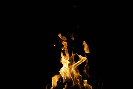 Burning flame or fire isolated on black background. stack of thermal energy close-up, red and yellow, heat energy igniting fuel during night,light on black background.の写真素材