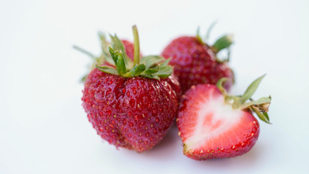 Red strawberries on white wooden table and farmland backgroundの写真素材