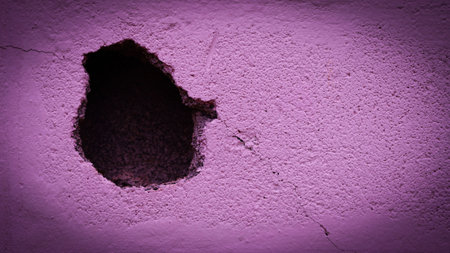 Pink plaster wall with holes from cracks. pink background, empty concrete wall, empty space, For use in making a background graphic design.の写真素材