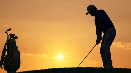 silhouette golfer playing golf with golf bag during beautiful sunset, concept healthy, copy space for put textの写真素材