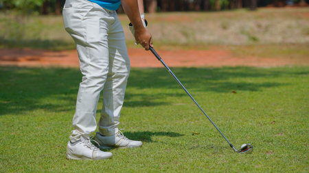Golfer playing golf in the evening golf course, on sun set evening time, Man playing golf on a golf course in the sun.の写真素材