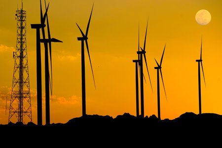 silhouette of Windmill, Wind Power Generator, Pollution-Free, Sunset and wind power plant.の写真素材