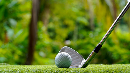 Golf club and golf ball close up in grass field with sunset. Golf ball close up in golf coures at Thailand.の写真素材
