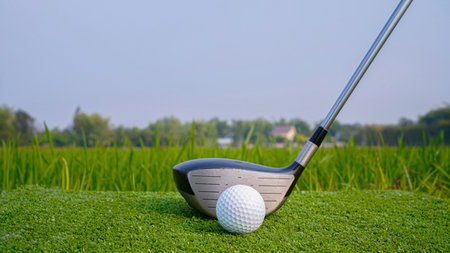 Golf club and ball in green grass. Golf balls on the golf course with golf clubs ready for golf in the first short.の写真素材