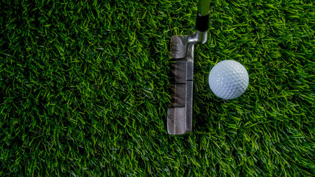 Golf clubs and balls on a green lawn in a beautiful golf course with morning sunshine. Close up of golf equipment on green grass.の写真素材