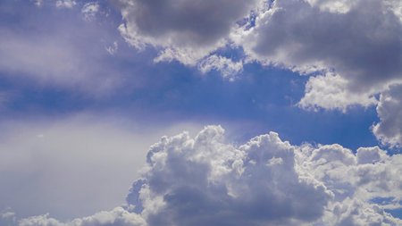 Sky background texture. Clean air daytime bright blue sky and clouds white clouds at noon in summer.の写真素材