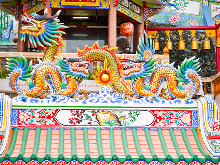 twin china dragon and big dragon statue on the roofの写真素材