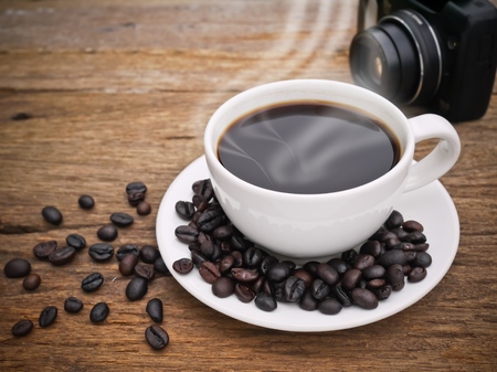 Hot dark espresso coffee cup with close up on the woodの写真素材