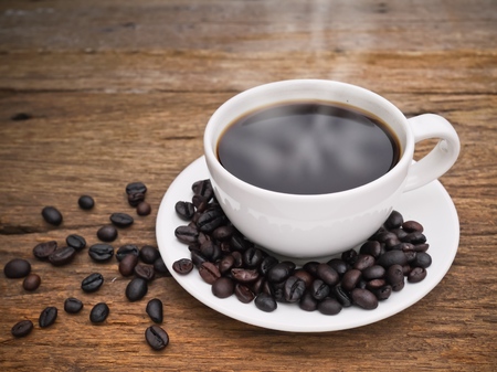 Hot dark espresso coffee cup with close up on the woodの写真素材