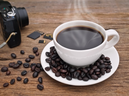 Hot dark espresso coffee cup with close up on the woodの写真素材