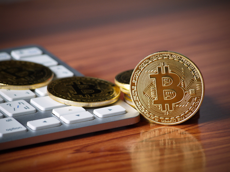 digital money golden bitcoin on the wood working tableの写真素材