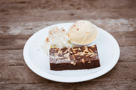 Brownie on white plate with ice creamの写真素材