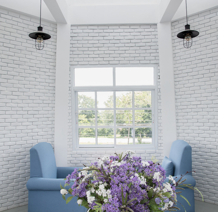 blue classic armchair in modern loft living room with white brick wallのeditorial素材