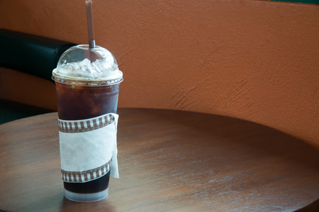 Iced Americano black coffee on a wooden tableの写真素材