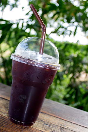 Iced Americano black coffee on a wooden tableの写真素材