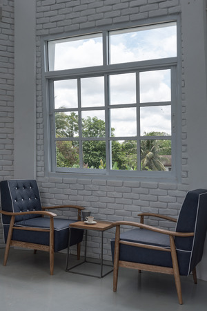 blue classic armchair in modern loft living room with white brick wallの写真素材