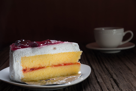 Vanilla cake topping with raspberry on old woodenの写真素材