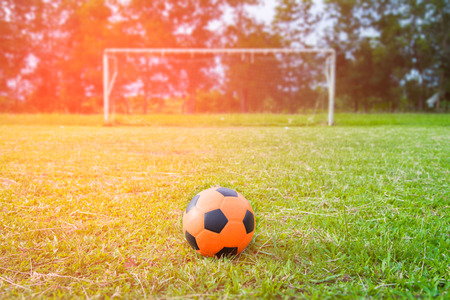 Orange soccer ball on the lawn