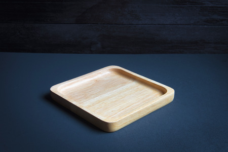 Wood plate on wooden table over grunge background