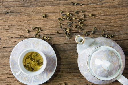 Tea cup and teapot on wooden tableの写真素材