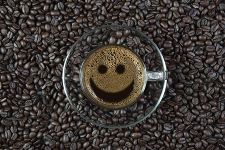 espresso in a glass on wooden table / smile coffeeの写真素材