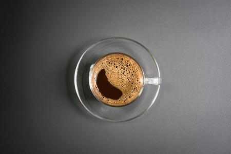 espresso in a glass on wooden tableの写真素材