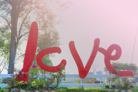 Red love lettering on nature backgroundの写真素材